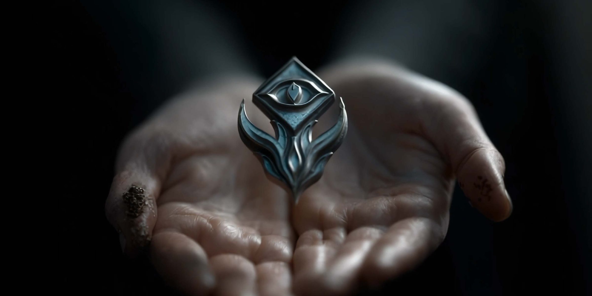 A pair of pale, open cupped hands held out in near-darkness, holding a floating diamond-shaped silver amulet inlaid with muted teal-blue stone and engraved with a single eye, with curved talon-like prongs beneath it. The